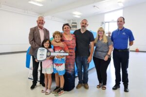 A family who received a car , Allstate Insurance representatives and G&C Auto Representatives